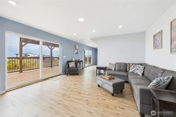 a living room with furniture and a wooden floor