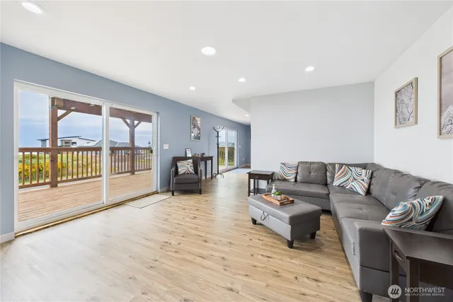 a living room with furniture and a wooden floor