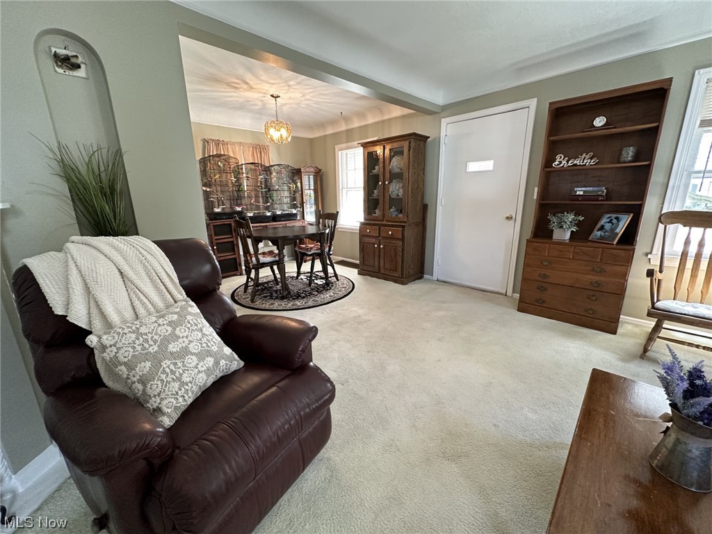 14422 Alger Road Cleveland, OH 44111 - Photo 6 of 16 Carpeted living room with a wealth of natural light and a chandelier