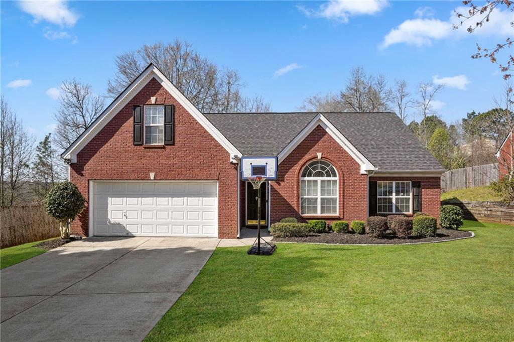 630 James Ridge Drive Lawrenceville, GA 30045 - Photo 1 of 1 a front view of a house with a yard and garage
