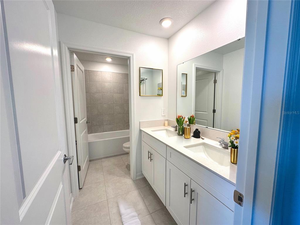 118 Inman Boulevard Winter Haven, FL 33881 - Photo 11 of 19 a bathroom with a granite countertop sink a toilet and shower