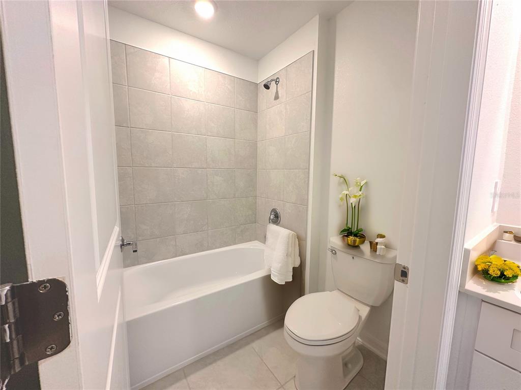118 Inman Boulevard Winter Haven, FL 33881 - Photo 12 of 19 a white bath tub sitting next to a white toilet and sink