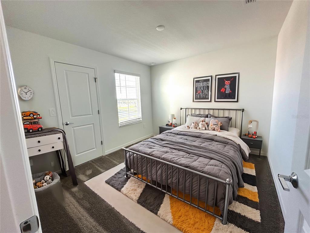 118 Inman Boulevard Winter Haven, FL 33881 - Photo 13 of 19 a bedroom with a bed and a window