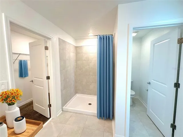 a bathroom with a shower and a toilet