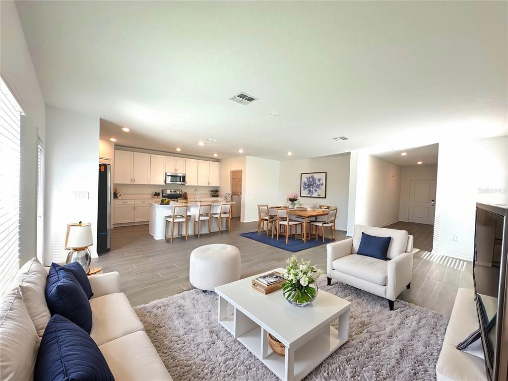 118 Inman Boulevard Winter Haven, FL 33881 - Photo 2 of 19 a living room with furniture kitchen view and a table