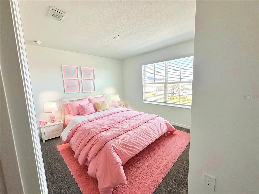118 Inman Boulevard Winter Haven, FL 33881 - Photo 4 of 19 a bedroom with a bed and a window