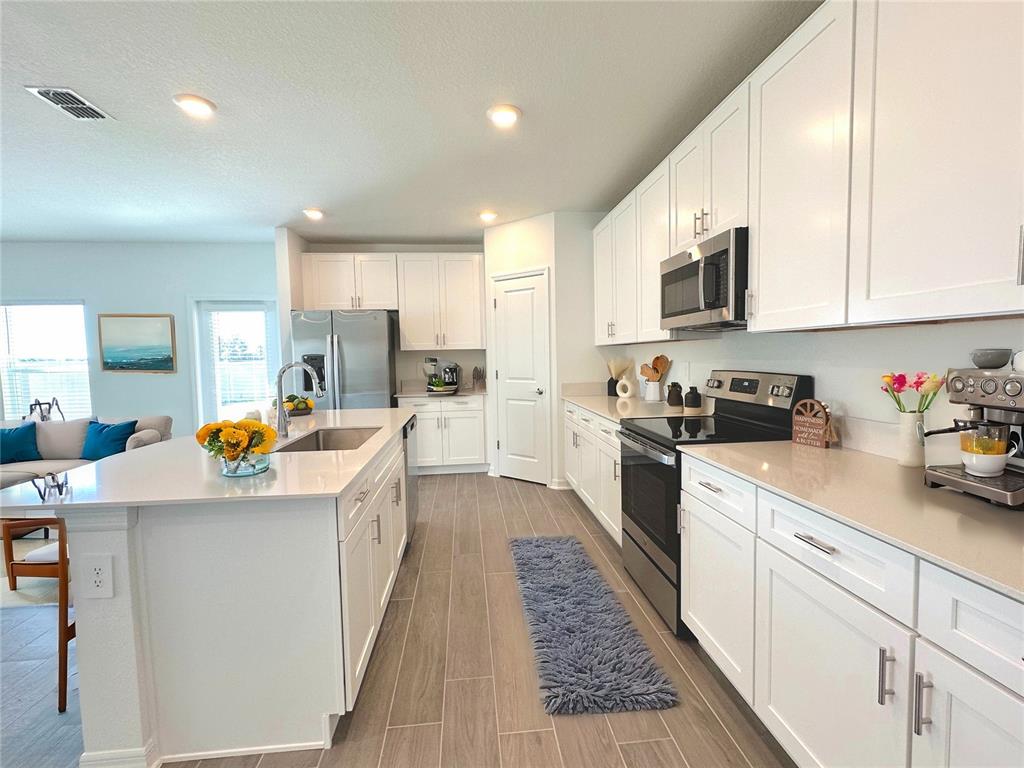 118 Inman Boulevard Winter Haven, FL 33881 - Photo 9 of 19 a kitchen with counter top space a sink appliances and cabinets