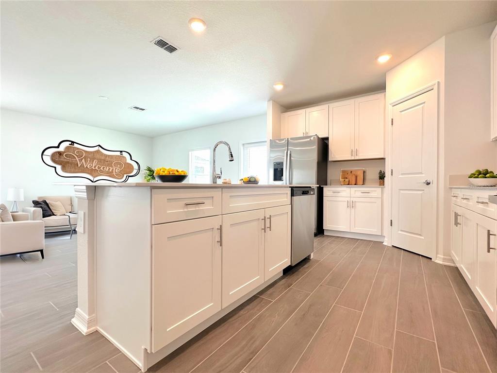 118 Inman Boulevard Winter Haven, FL 33881 - Photo 10 of 19 a kitchen with white cabinets and sink
