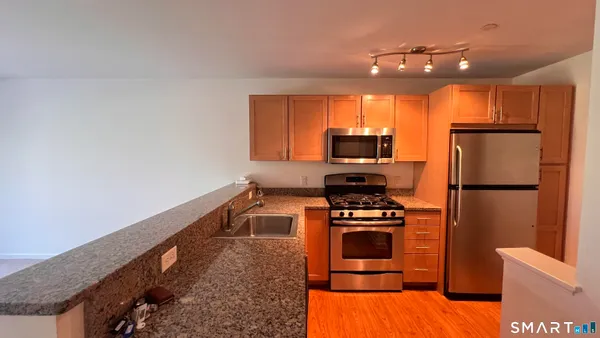 a kitchen with a refrigerator and a stove