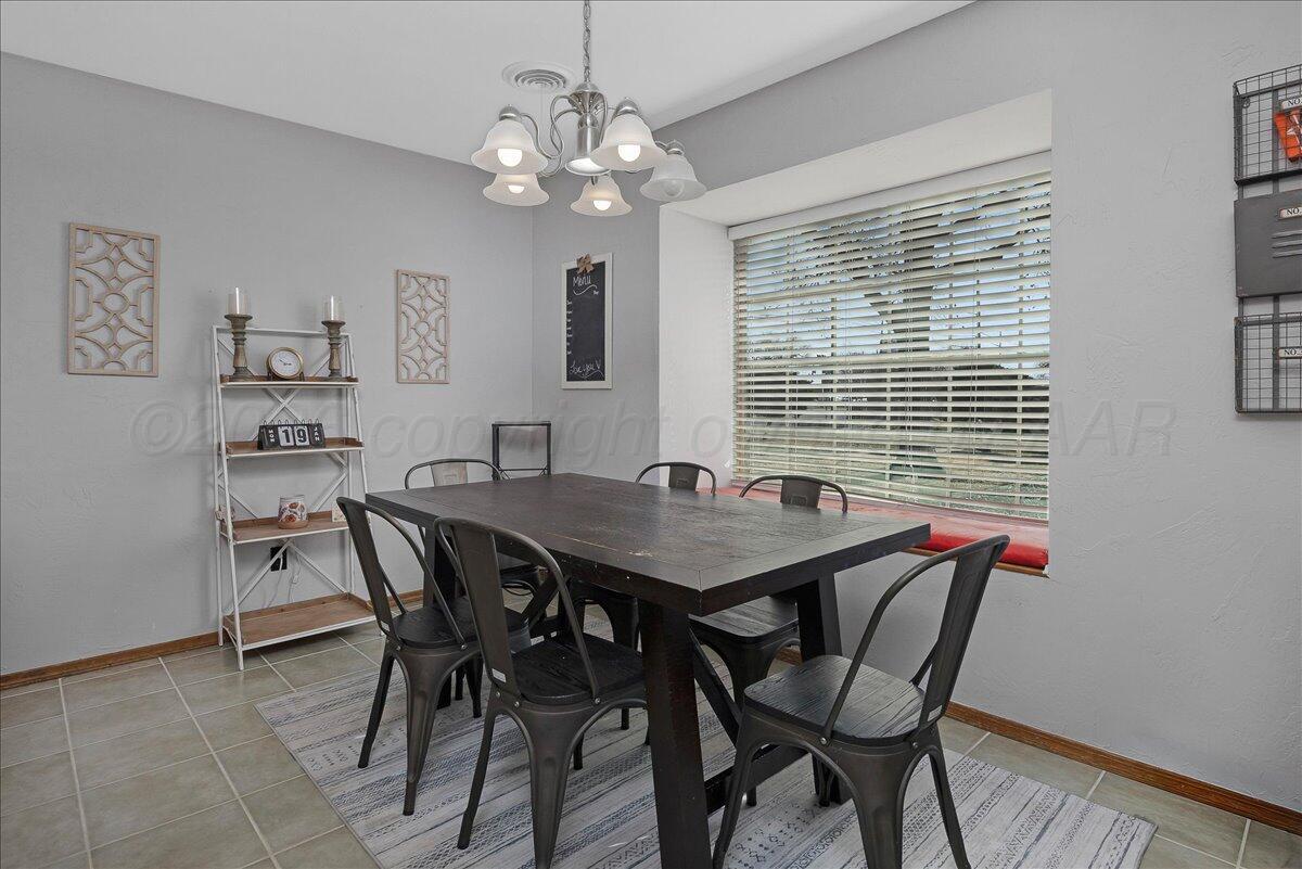 4202 Charles Street Amarillo, TX 79106 - Photo 12 of 27 a view of a dining room with furniture and window