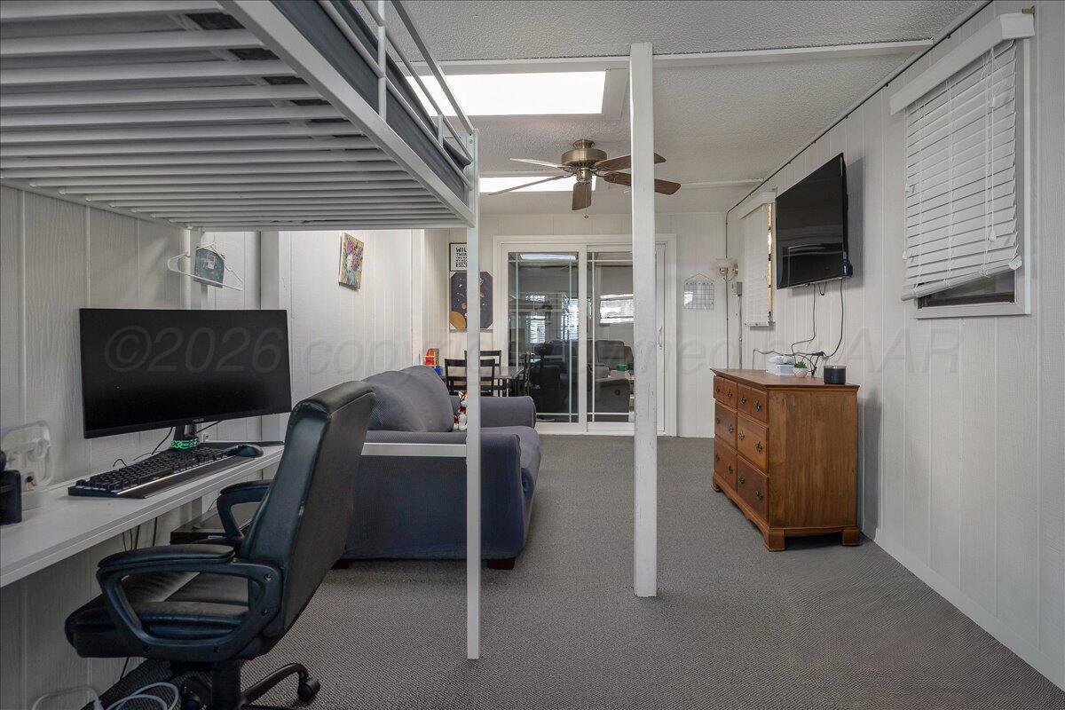 4202 Charles Street Amarillo, TX 79106 - Photo 14 of 27 a view of a livingroom with furniture and a flat screen tv