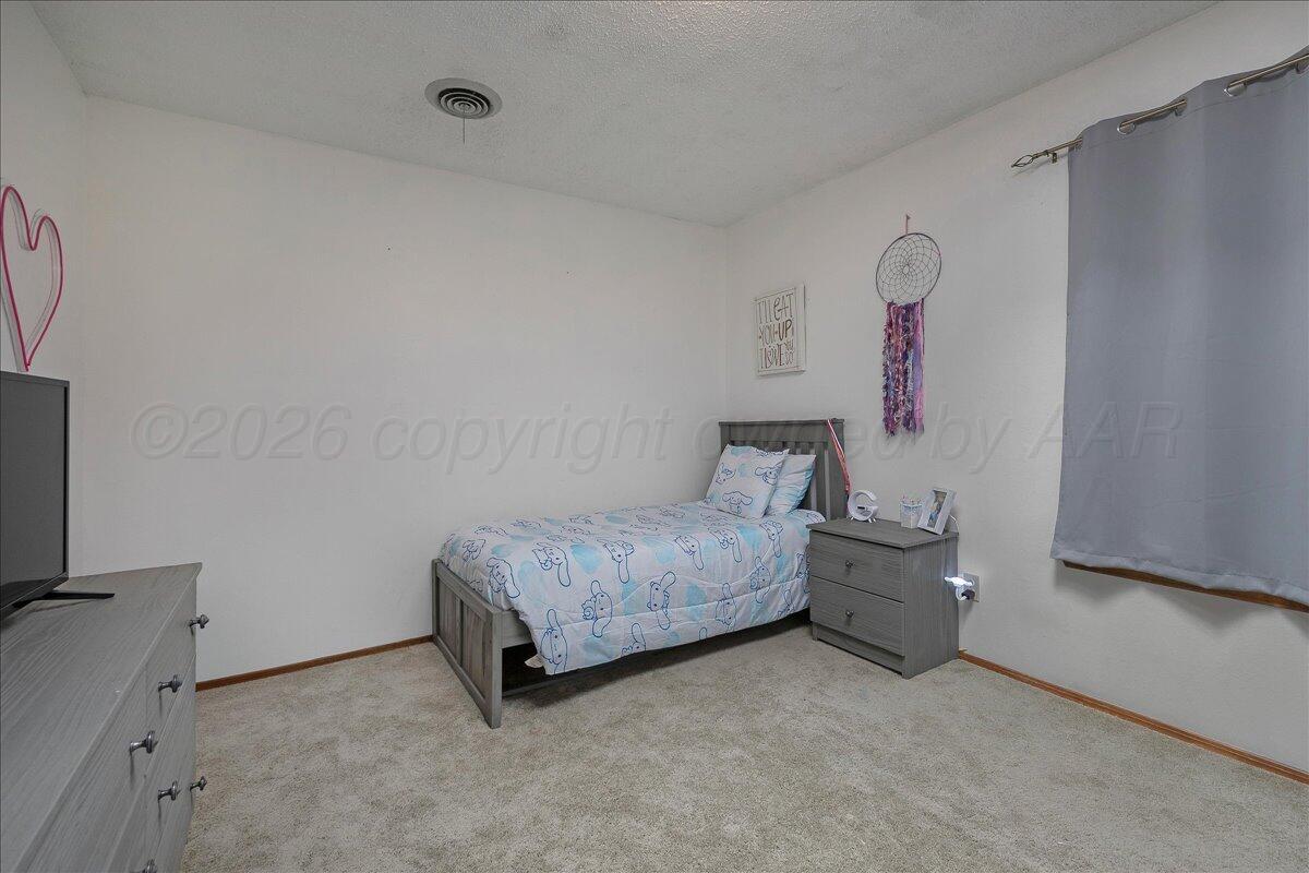 4202 Charles Street Amarillo, TX 79106 - Photo 20 of 27 a room with a table and a couch
