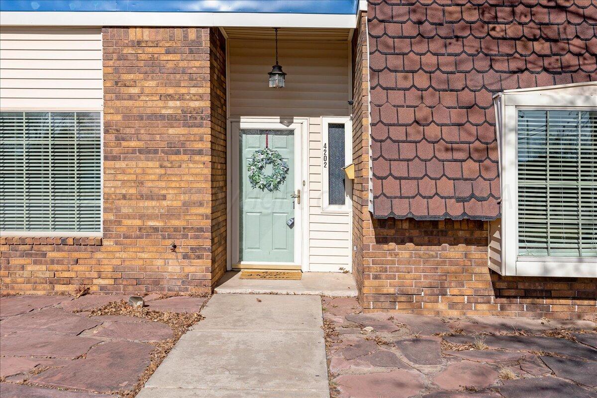 4202 Charles Street Amarillo, TX 79106 - Photo 2 of 27 a view of a brick house with a large window