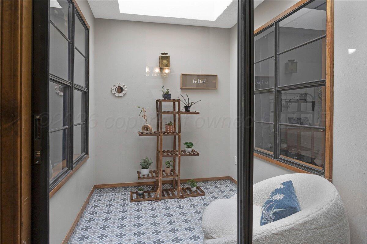 4202 Charles Street Amarillo, TX 79106 - Photo 22 of 27 a view of a hallway with wooden floor and a rug