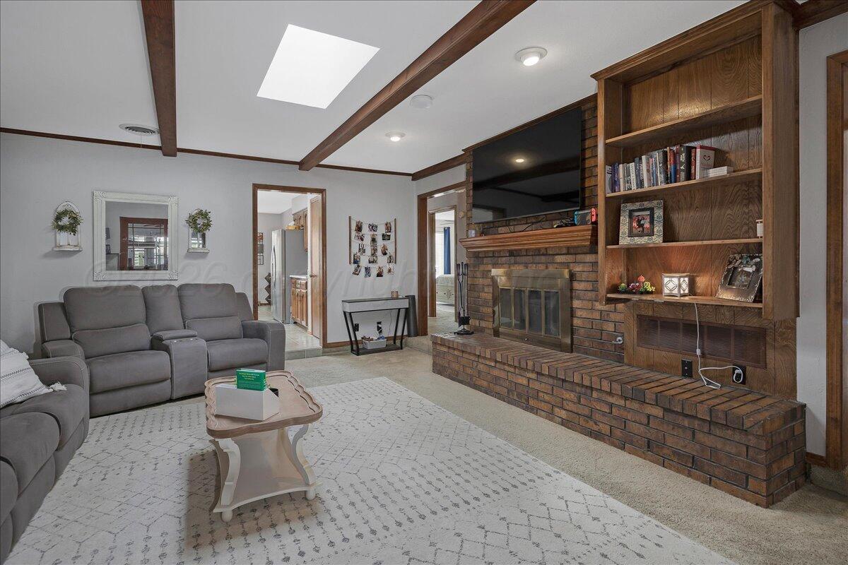 4202 Charles Street Amarillo, TX 79106 - Photo 4 of 27 a living room with furniture and a flat screen tv