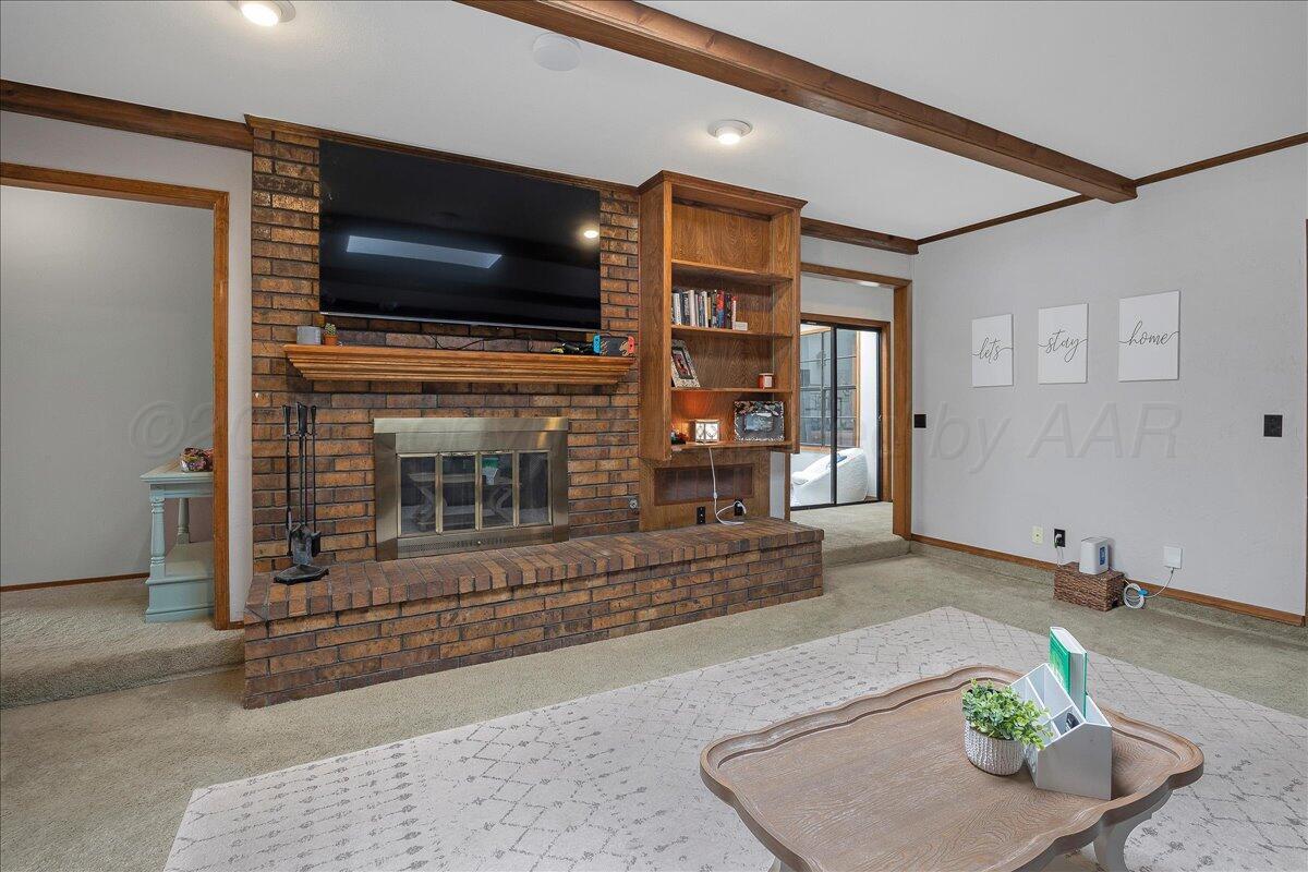 4202 Charles Street Amarillo, TX 79106 - Photo 5 of 27 a living room with fireplace furniture and a flat screen tv