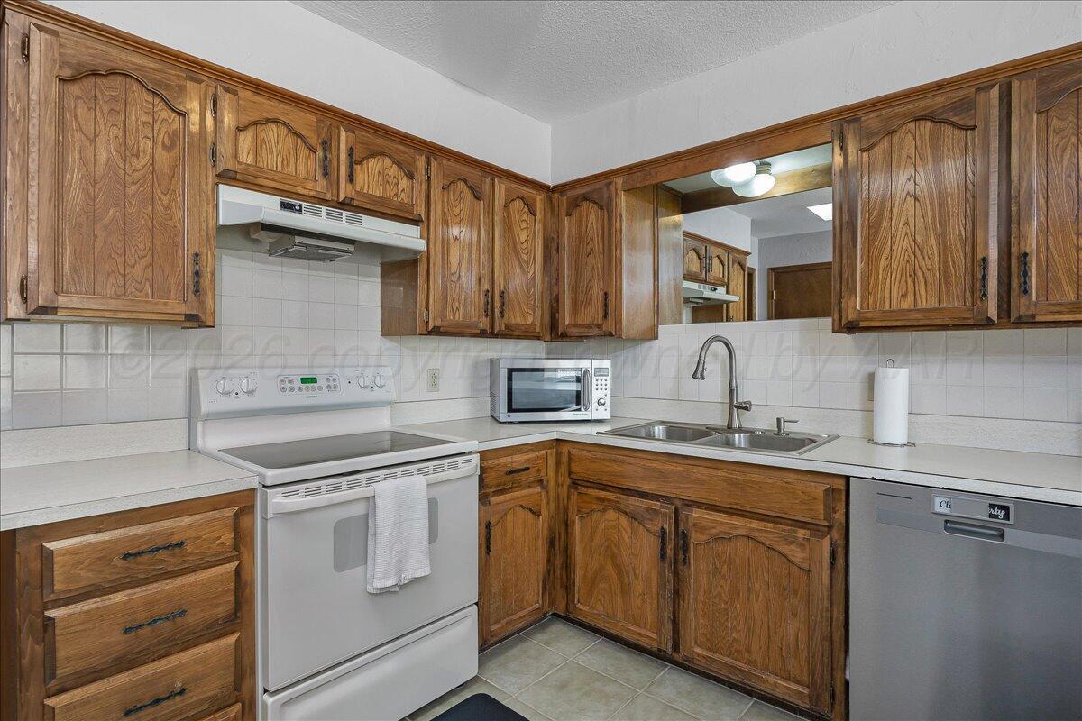 4202 Charles Street Amarillo, TX 79106 - Photo 9 of 27 a kitchen with a sink stove and cabinets
