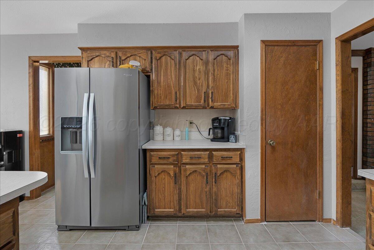 4202 Charles Street Amarillo, TX 79106 - Photo 10 of 27 a kitchen with stainless steel appliances granite countertop a refrigerator and a sink