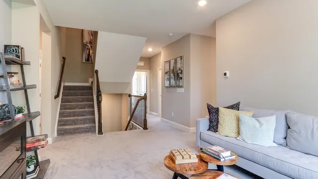 a living room with furniture and stairs