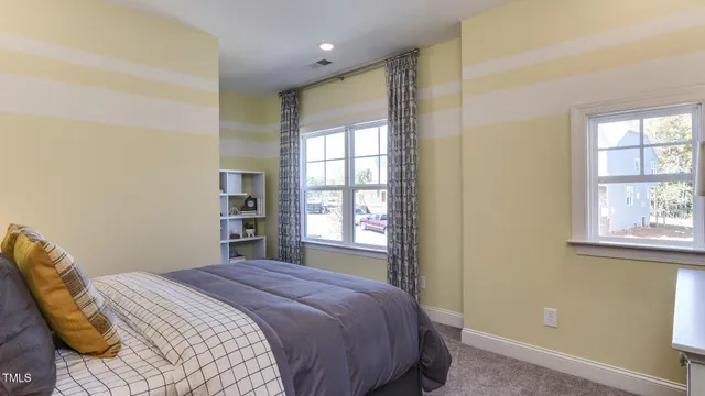 a bedroom with a bed and glass windows