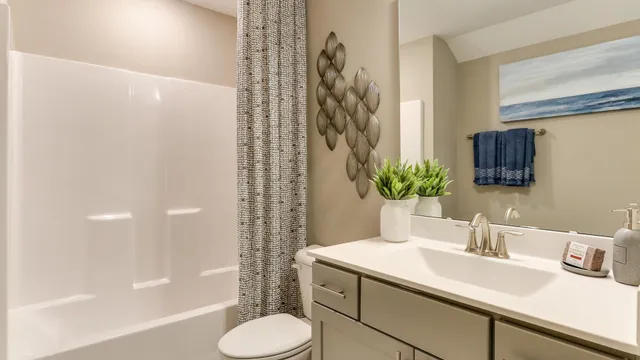 a bathroom with a granite countertop sink a toilet and shower