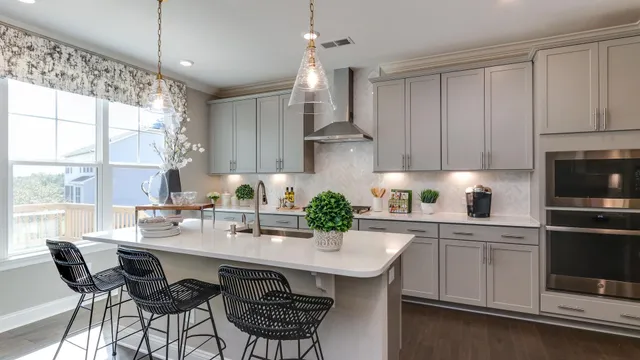 a kitchen with a white center island and cabinets
