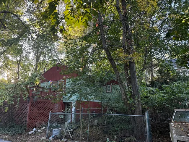 a view of house with outdoor space and sitting area