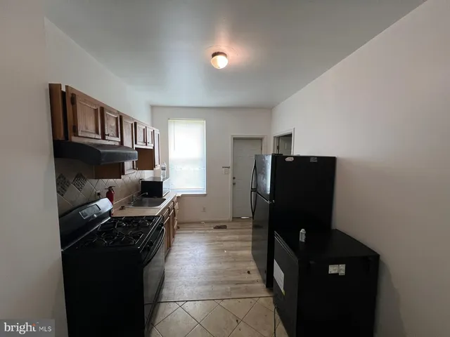 a kitchen with a refrigerator and a stove