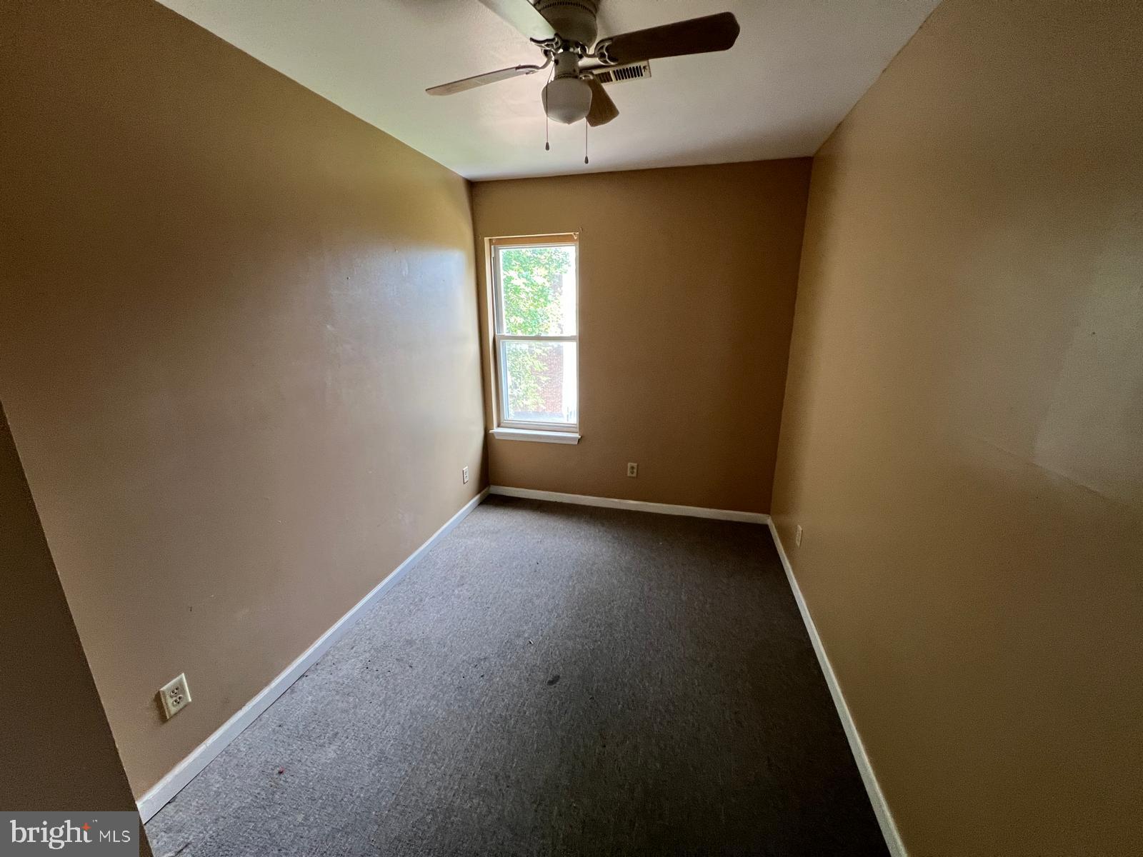 3907 Fairview Avenue Baltimore, MD 21216 - Photo 18 of 25 an empty room with windows and fan