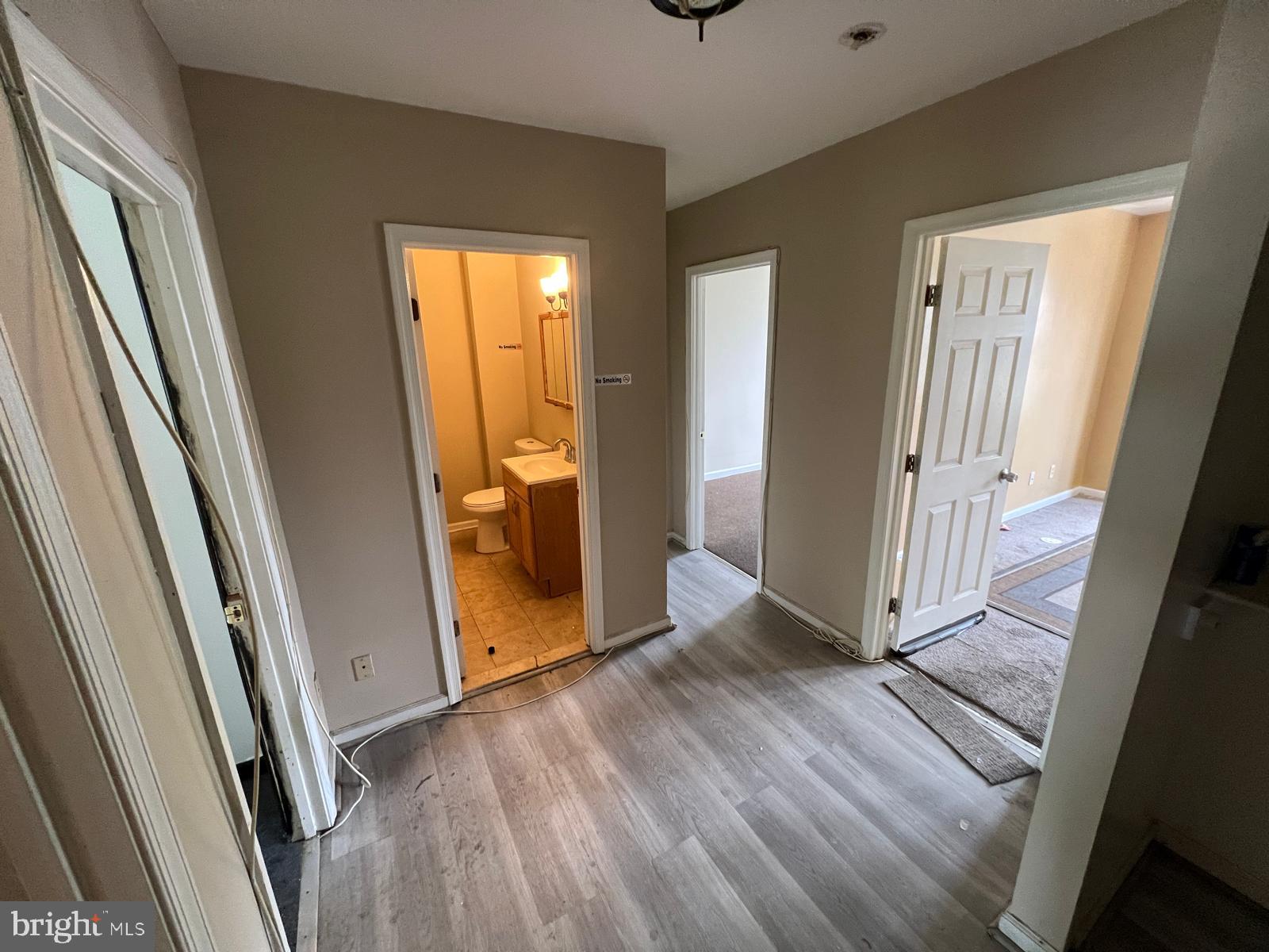 3907 Fairview Avenue Baltimore, MD 21216 - Photo 21 of 25 a view of a hallway with wooden floor and a window