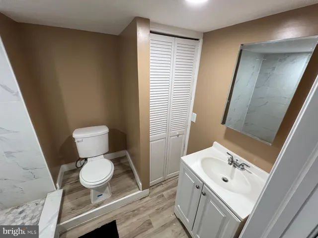 a bathroom with a sink toilet a mirror and vanity