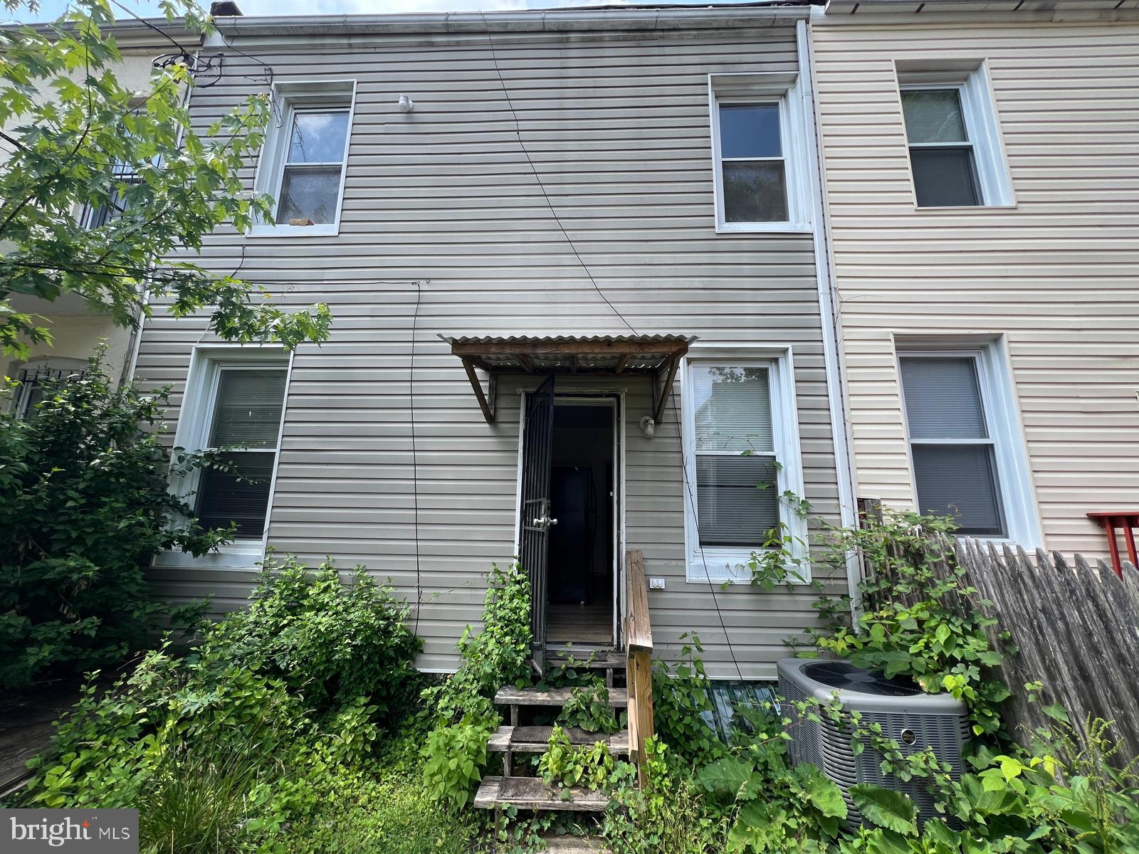 3907 Fairview Avenue Baltimore, MD 21216 - Photo 5 of 25 a front view of a house with plants