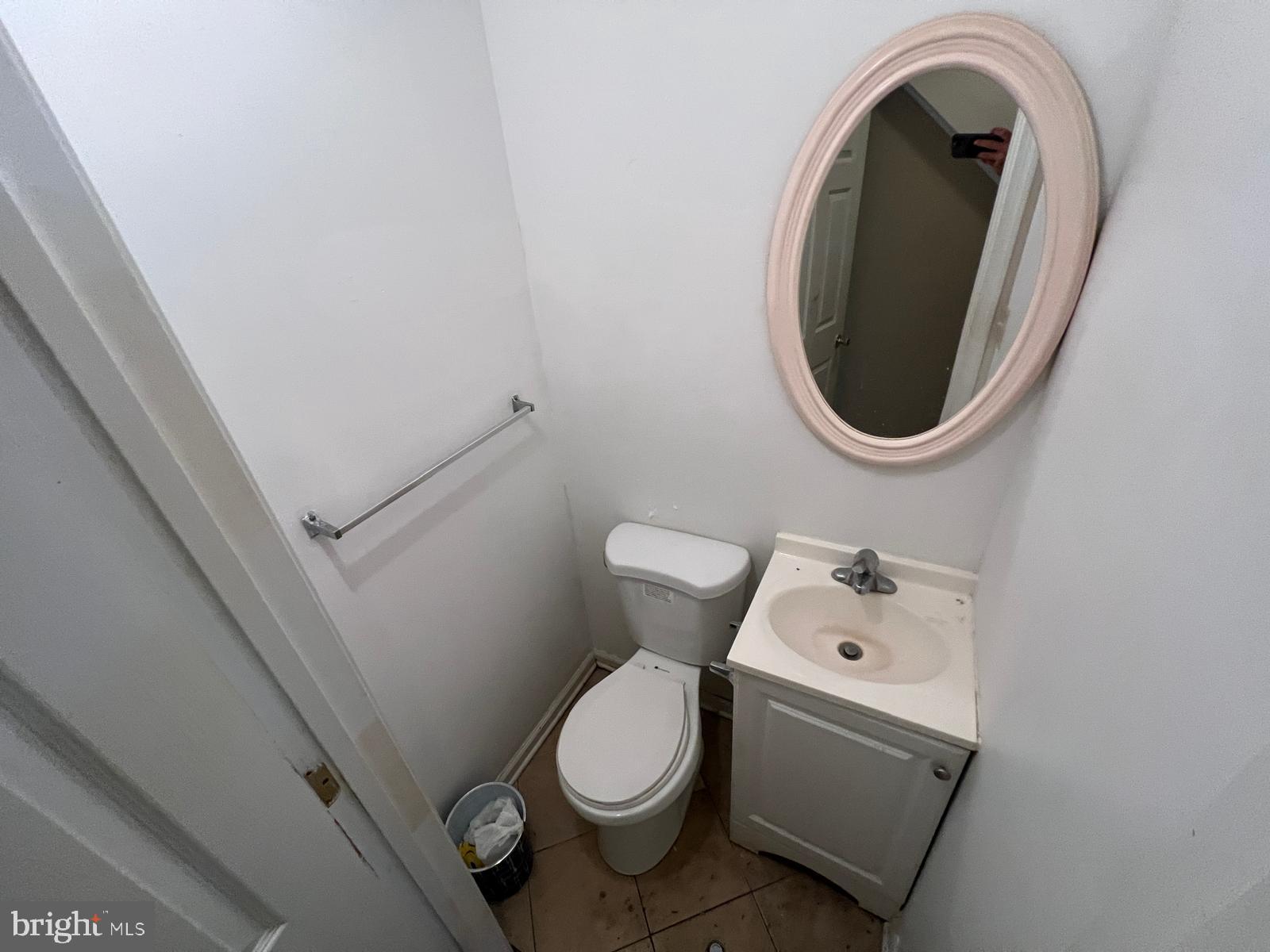 3907 Fairview Avenue Baltimore, MD 21216 - Photo 10 of 25 a white toilet sitting next to a bathroom sink