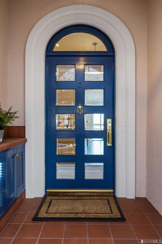 a hall way with furniture a wooden floor and a large window
