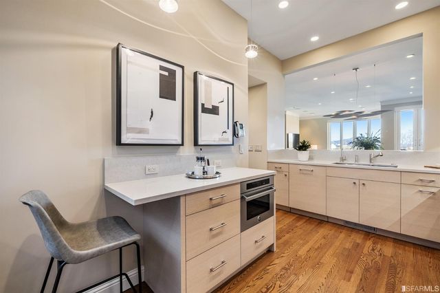 a en suite bathroom with a granite countertop double sink and a mirror
