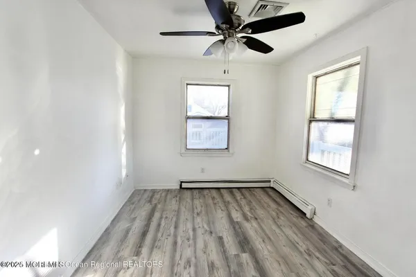 wooden floor in an empty room with a window