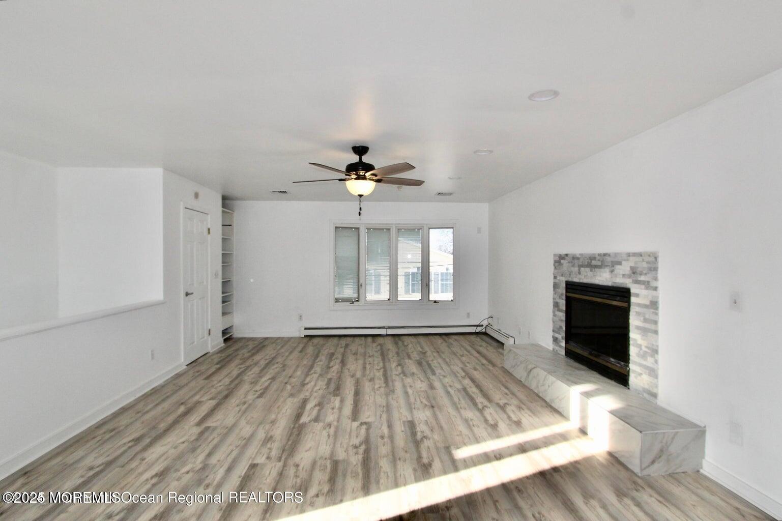 9 Kearney Street, Unit A Keyport, NJ 07735 - Photo 14 of 37 an empty room with windows and fireplace