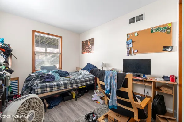 a bedroom with bed and a flat screen tv