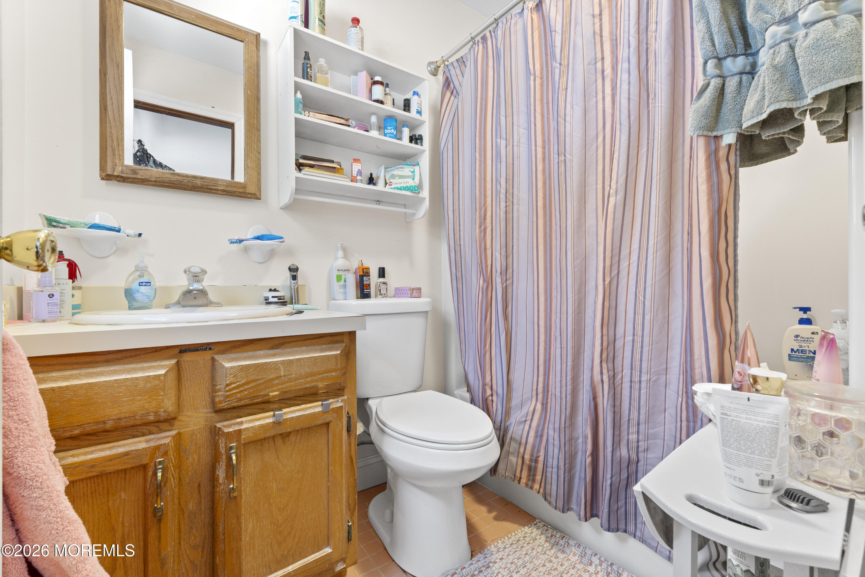 9 Kearney Street, Unit A Keyport, NJ 07735 - Photo 22 of 37 a bathroom with a sink a toilet and shower curtain