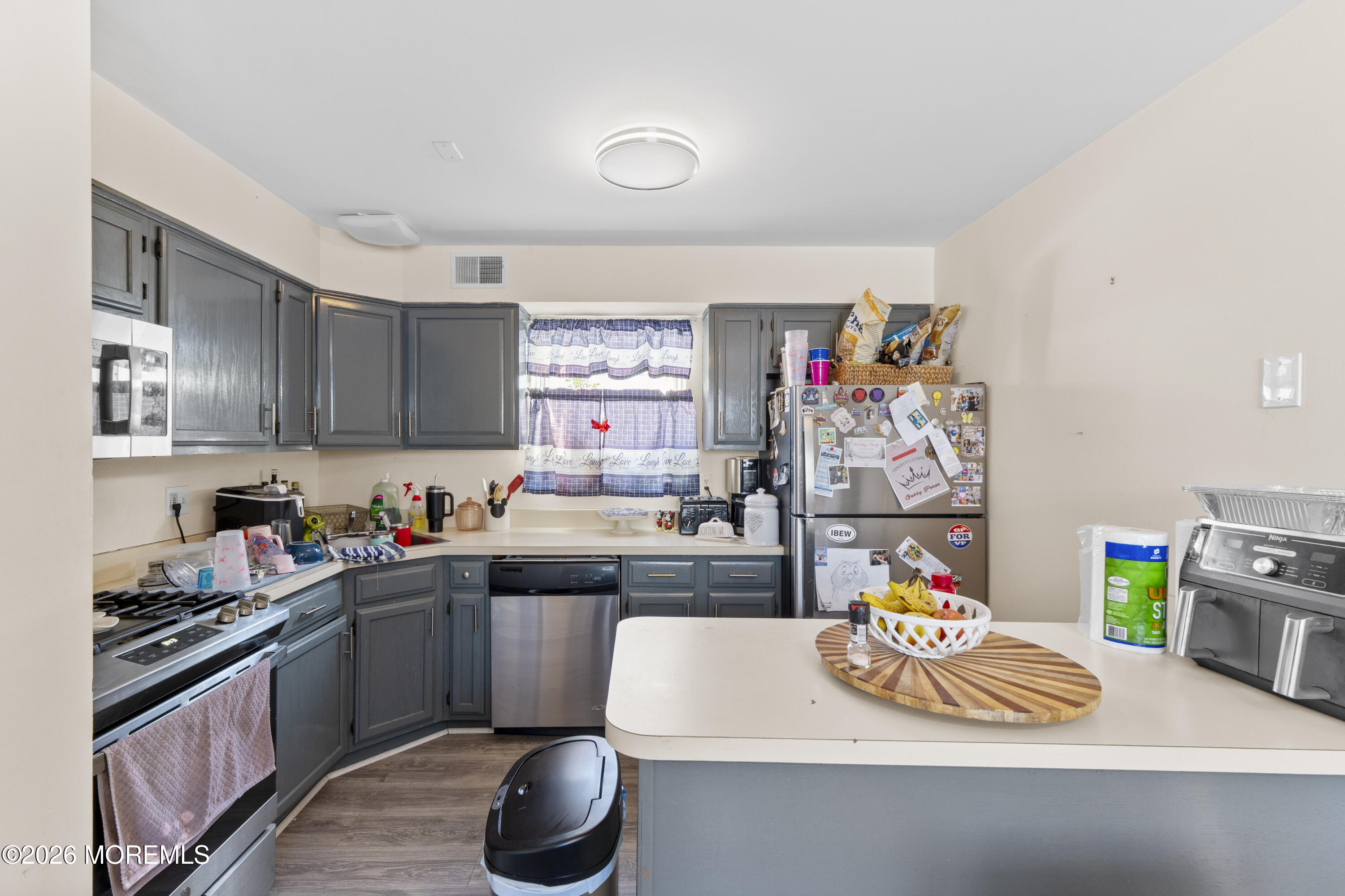 9 Kearney Street, Unit A Keyport, NJ 07735 - Photo 24 of 37 a kitchen with a sink a stove and lots of wooden cabinets