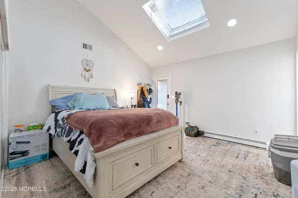 a spacious bedroom with a bed and a window