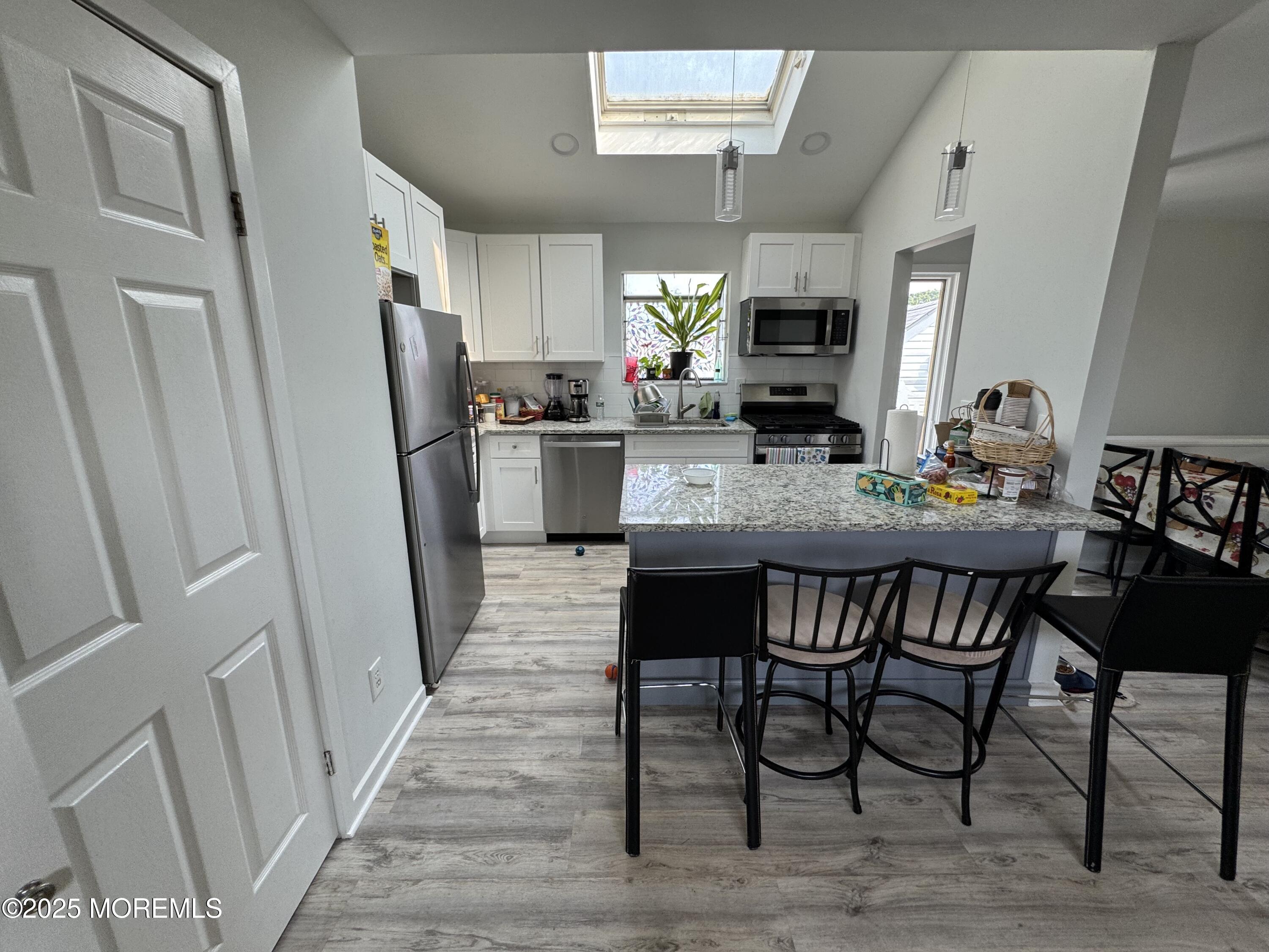 9 Kearney Street, Unit A Keyport, NJ 07735 - Photo 5 of 37 a view of a dining room with furniture and wooden floor