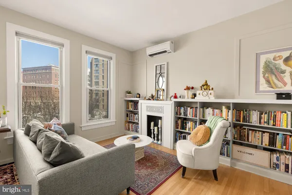 a living room with fireplace furniture and a book shelf