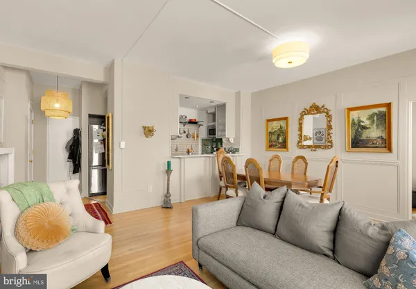 a living room with furniture and a lamp