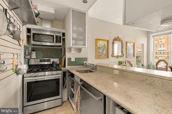 a kitchen with stainless steel appliances granite countertop a stove and a sink