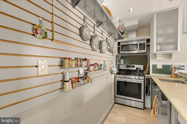 a utility room with stainless steel appliances and a stove