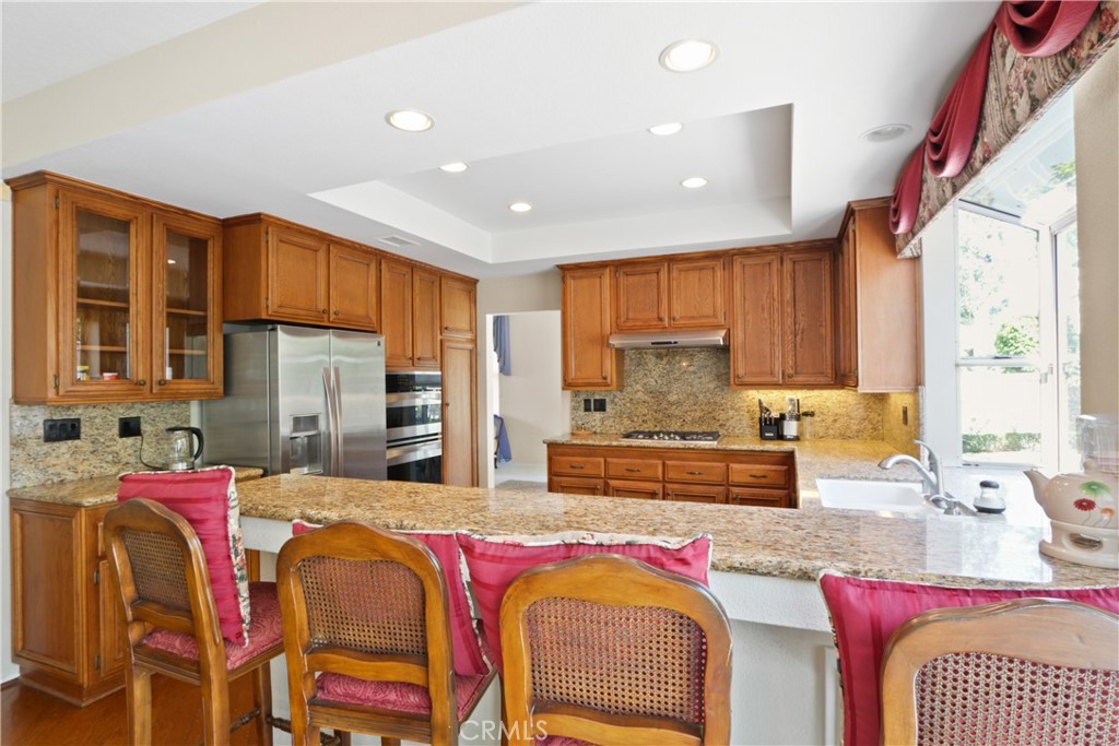 14 Terraza Irvine, CA 92614 - Photo 3 of 16 a large kitchen with stainless steel appliances granite countertop a sink and cabinets