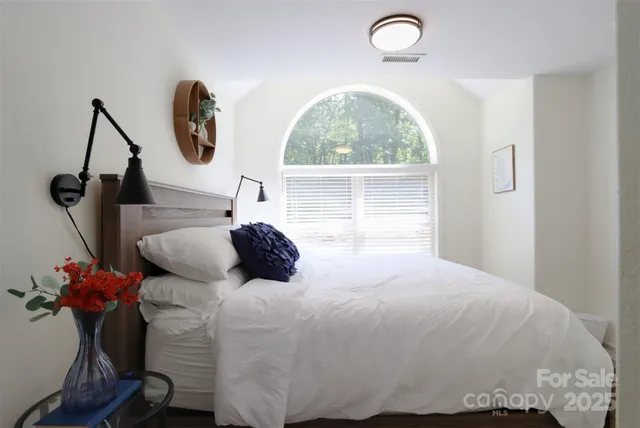 a bedroom with a bed and a window