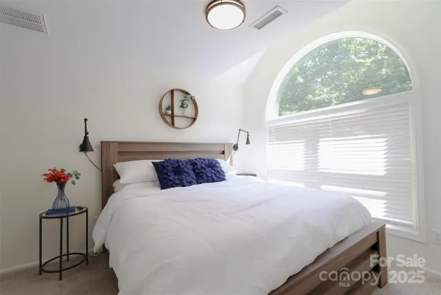 a bedroom with a bed and window