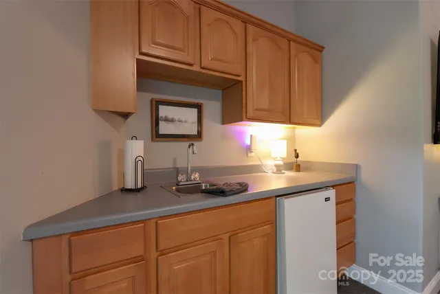 a kitchen with stainless steel appliances a sink and cabinets